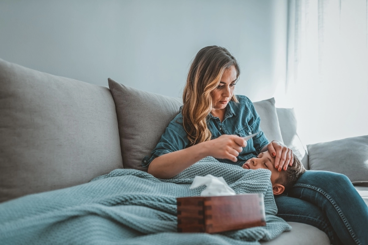 mom with sick child on couch